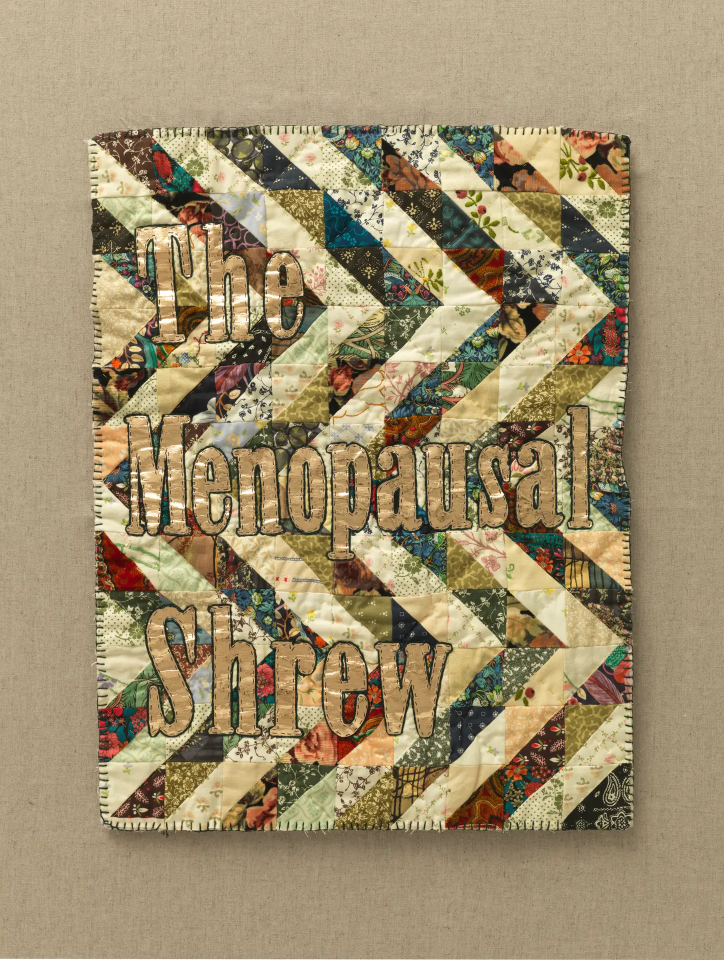 patchwork fabric slogan writing in gold fabric